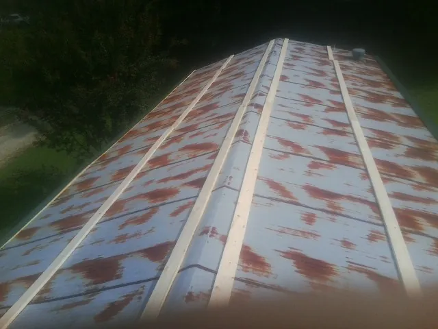 Rusted metal roof panels with new wood purlins before replacement — Storm Damage Roof Repair in Great Cacapon by Roofing Brothers